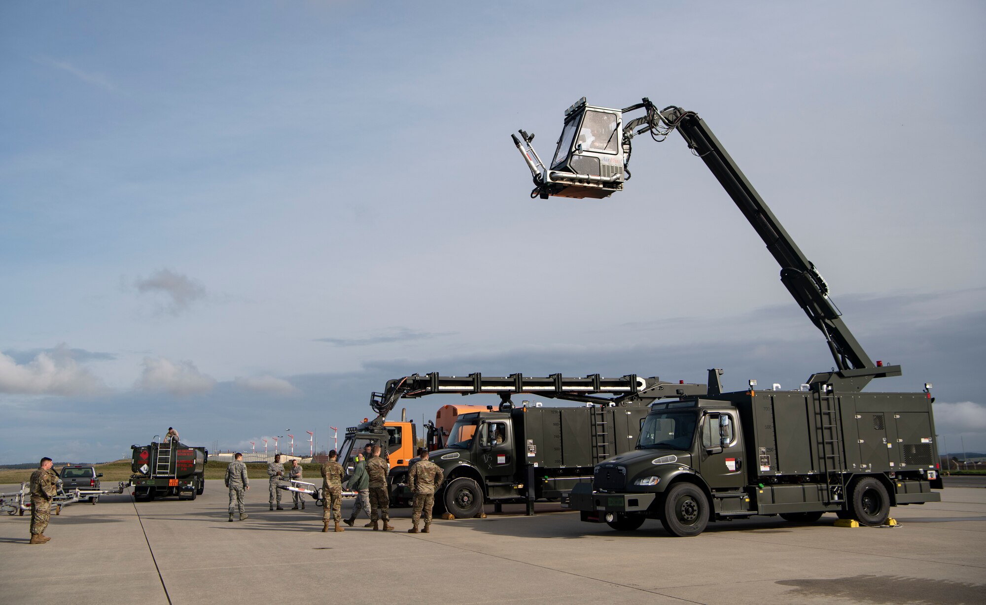 U.S. Air Force Chief Master Sgt. Stephanie Cates, 52nd Fighter Wing command chief, top right, operates an aircraft deicer during a snow and ice parade at Spangdahlem Air Base, Germany, Nov. 8, 2019. The parade allowed the 52nd Civil Engineer Squadron to show leadership winter equipment which keeps the runway open and ensures the mission continues without interruption. (U.S. Air Force photo by Staff Sgt. Preston Cherry)