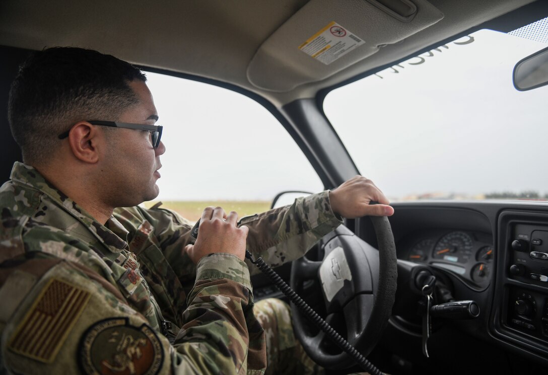 U.S. Air Force Staff Sgt. Deuderit Colon De Jesus, an airfield management operations supervisor from the 31st Operations Support Squadron, uses a radio to request permission from the air traffic control tower to cross the runway at Aviano Air Base, Italy, Nov. 13, 2019. The 31st Operations Support Squadron develops wing war plans, administers weapons and tactics programs and provides current operations planning, air traffic control, airfield management, weather and intelligence support. (U.S. Air Force photo by Airman 1st Class Ericka A. Woolever).