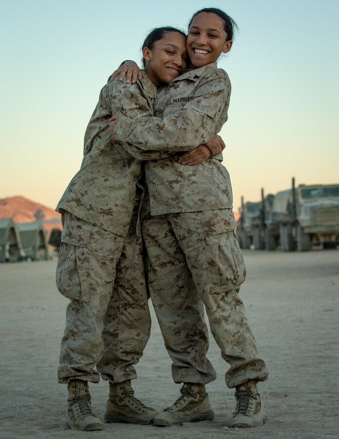 U.S. Marine Corps Cpl. Tiana Kemp, right, and Lance Cpl. Briana Kemp, both supply administration specialists with Combat Logistics Regiment (CLR) 2, 2nd Marine Logistics Group (MLG), pose for a photograph at Camp Wilson, Marine Corps Air Ground Combat Center, Twentynine Palms, California, Nov. 8, 2019. The Kemp twins participated in the MAGTF Warfighting Exercise (MWX) 1-20 together. MWX was 2nd Marine Division’s largest unscripted, force-on-force, exercise in several decades. (U.S. Marine Corps photo by Sgt. Stormy Mendez)
