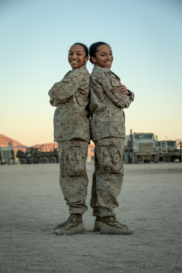 U.S. Marine Corps Cpl. Tiana Kemp, right, and Lance Cpl. Briana Kemp, both supply administration specialists with Combat Logistics Regiment (CLR) 2, 2nd Marine Logistics Group (MLG), pose for a photograph at Camp Wilson, Marine Corps Air Ground Combat Center, Twentynine Palms, California, Nov. 8, 2019. The Kemp twins participated in the MAGTF Warfighting Exercise (MWX) 1-20 together. MWX was 2nd Marine Division’s largest unscripted, force-on-force, exercise in several decades. (U.S. Marine Corps photo by Sgt. Stormy Mendez)