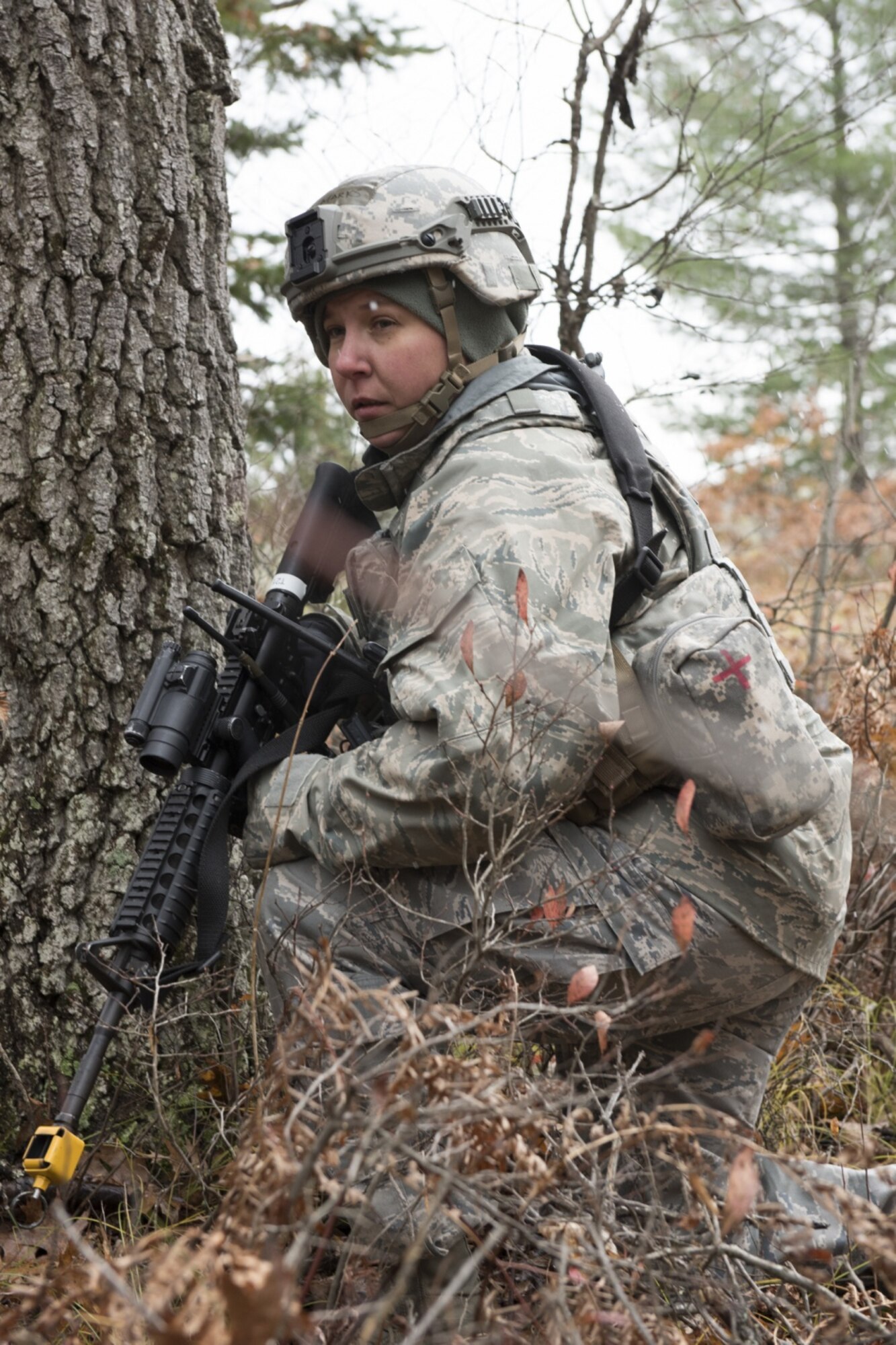 U.S. Air Force Master Sgt. Tammy Marks, assigned to the Security Forces Squadron at the 167th Airlift Wing, West Virginia Air National Guard, kneels in a wooded area during a combat training scenario in Alpena, Mich., Nov. 5, 2019. Approximately 300 members assigned to the 167th deployed to the Combat Readiness Training Center Nov. 3-7. (U.S. Air National Guard photo by Senior Master Sgt. Emily Beightol-Deyerle)