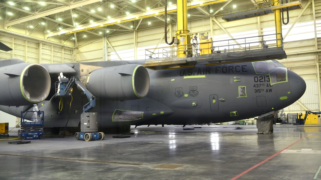 Members of the 437th Maintenance Squadron, Fabrication Flight corrosion control and structural repair sand a C-17 during routine maintenance Oct.17, 2019, at Joint Base Charleston, S.C. Sanding is one of the steps that needs to be completed while at the CCR. Approximately 12 aircraft go through the corrosion control process annually and it takes approximately two weeks complete each C-17.