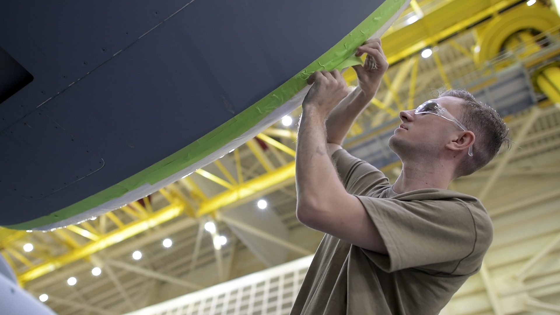 Senior Airman Ian Roush, 437th Maintenance Squadron, Fabrication Flight corrosion control and structural repair, pre-masks a C-17 engine prior to sanding the Aircraft Oct. 15, 2019, at Joint Base Charleston, S.C. Pre-masking is the first step prior to painting the aircraft. Approximately 12 aircraft go through the corrosion control process annually and it takes approximately two weeks complete each C-17.