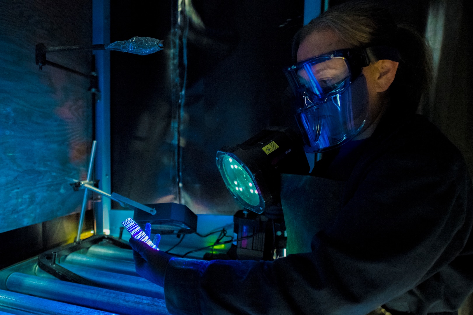 Amber Wedding, 437th Non Destructive Inspection test lead, checks a cracked chrome panel from a C-17 with a penetrant inspection system Nov. 1, 2019, at Joint Base Charleston, S.C. The penetrant inspection systems is designed for testing parts for defects or inconsistencies.
