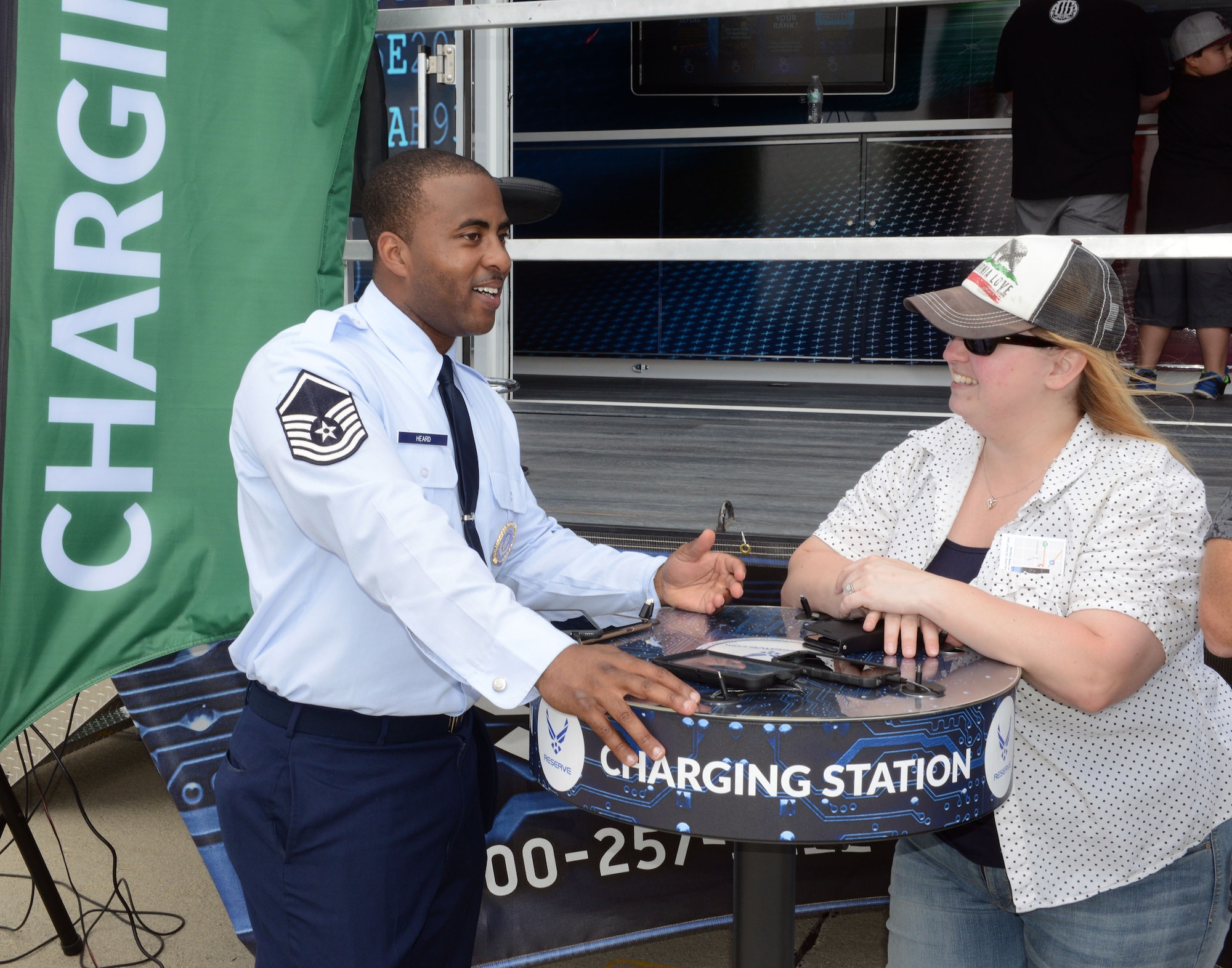 Master Sgt. Marquise Heard won the Mike Mungavin award for the Air Force Reserve Command Recruiting Service for fiscal year 2019. Heard, a recruiter for March Air Reserve Base, California,seen here talking to an air show attendee at the charging station of the new Air Force Reserve mobile marketing platform at the March Air Reserve Base Air and Space Expo. (Air Force photo/Master Sgt Chance Babin)