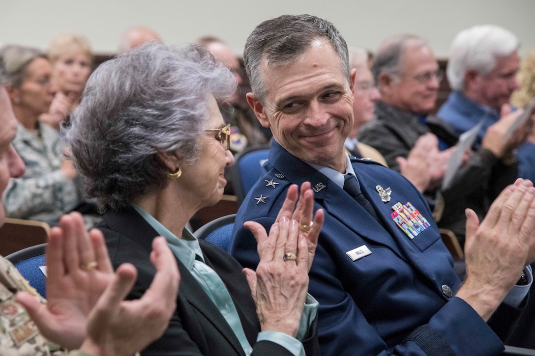 U.S. Air Force Maj. Gen. Craig Wills, 19th Air Force commander, shares a smile alongside Nancy Crawford, wife of the late Oliver “Ollie” Crawford during the 558th Flying Training Squadron’s building dedication ceremony Nov. 13, 2019, at Joint Base San Antonio-Randolph, Texas. Ollie Crawford was a pilot, charter member of the Air Force Association and was instrumental in the formation of the Air Force Memorial in Washington, D.C. The newly-dedicated building is home to the 558th FTS, which is the sole source for all U.S. Air Force and U.S. Marine Corps undergraduate remotely piloted aircraft pilot and sensor operator training. (U.S. Air Force photo by Sean M. Worrell)