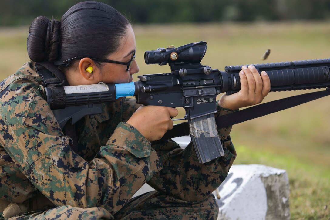 A Marine Corps recruit fires a weapon.