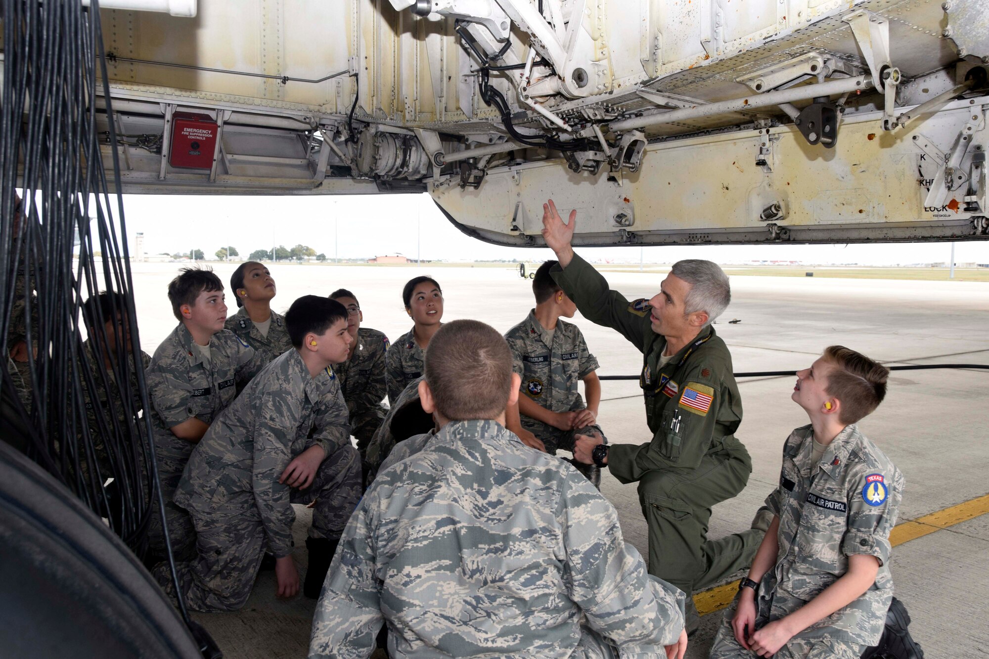 Maj. Matt Menendez, 68th Airlift Squadron pilot, talks to Civil Air Patrol cadets about the C-5M Super Galaxy landing gear to Civil Air Patrol cadets Nov. 6, 2019 at Joint Base San Antonio-Lackland, Texas (U.S. Air Force photo by Staff Sgt. Lauren M. Snyder)