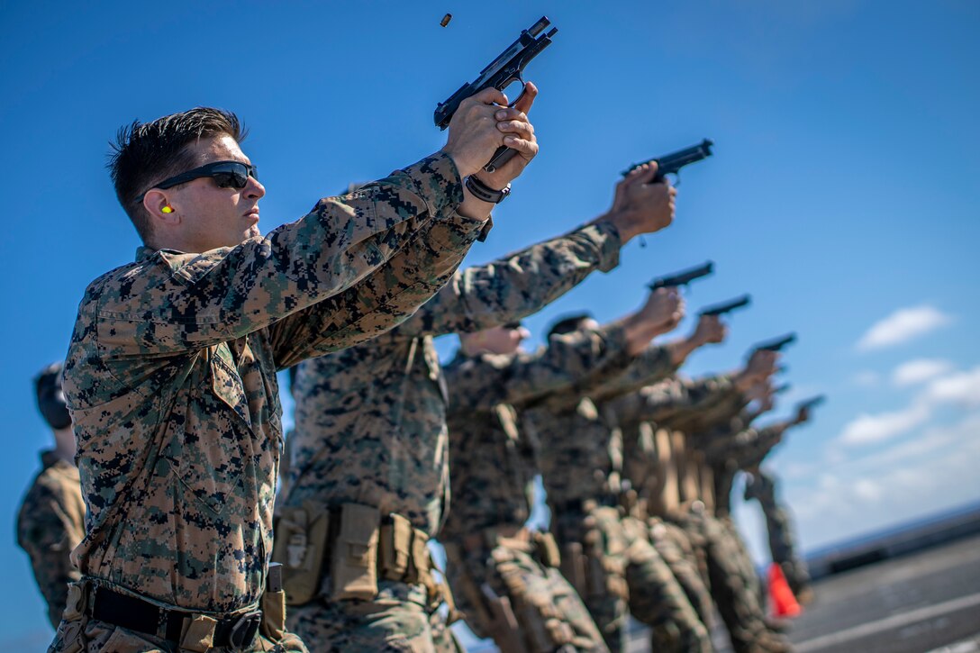 U.S. Marine Corps Staff Sgt. Scott Ingram, the anti-tank section chief with Alpha Company, Battalion Landing Team 3/5, 11th Marine Expeditionary Unit, fires an M9 pistol during a pistol qualification shoot aboard the San Antonio-class amphibious transport dock ship USS John P. Murtha. The Marines and Sailors of the 11th MEU are conducting routine operations as part of the Boxer Amphibious Ready Group in the eastern Pacific Ocean.