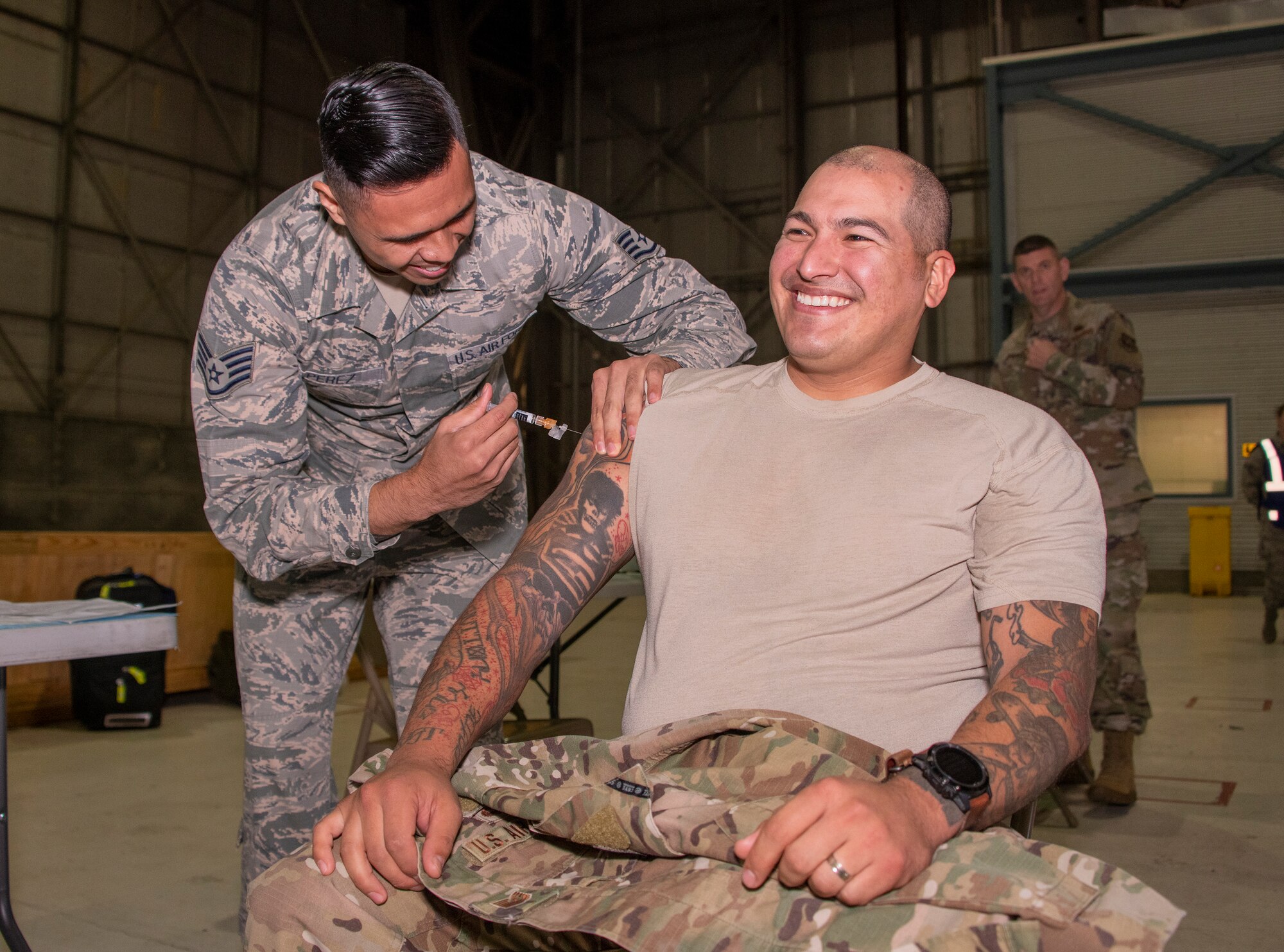 U.S. Air Force Staff Sgt. Harris Belmonte, 60th Aeromedical Squadron medical technician, prepares an influenza vaccine during a mass inoculation at the “Point of Distribution” during a base exercise Nov. 5, 2019, at Travis Air Force Base, California. The exercise tested Team Travis’ ability to respond to a public health emergency in the event of an actual health crisis. (U.S. Air Force photo by Heide Couch)