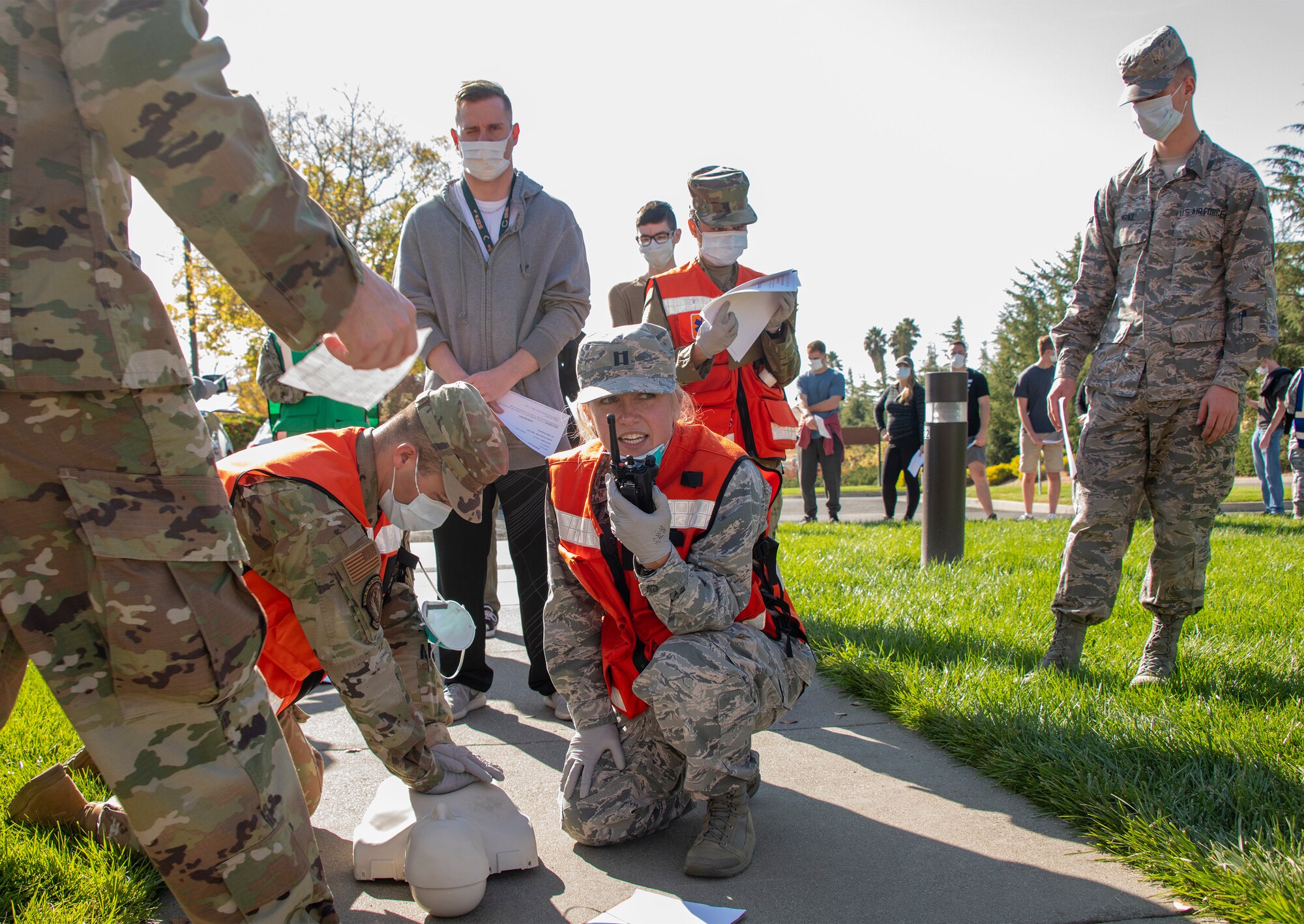 U.S. Air Force medical personnel assigned to David Grant USAF Medical Center administer emergency first aid to a simulated victim during a base exercise Nov. 5, 2019, at Travis Air Force Base, California. The exercise tested Team Travis’ ability to respond to a public health emergency in the event of an actual health crisis. (U.S. Air Force photo by Heide Couch)
