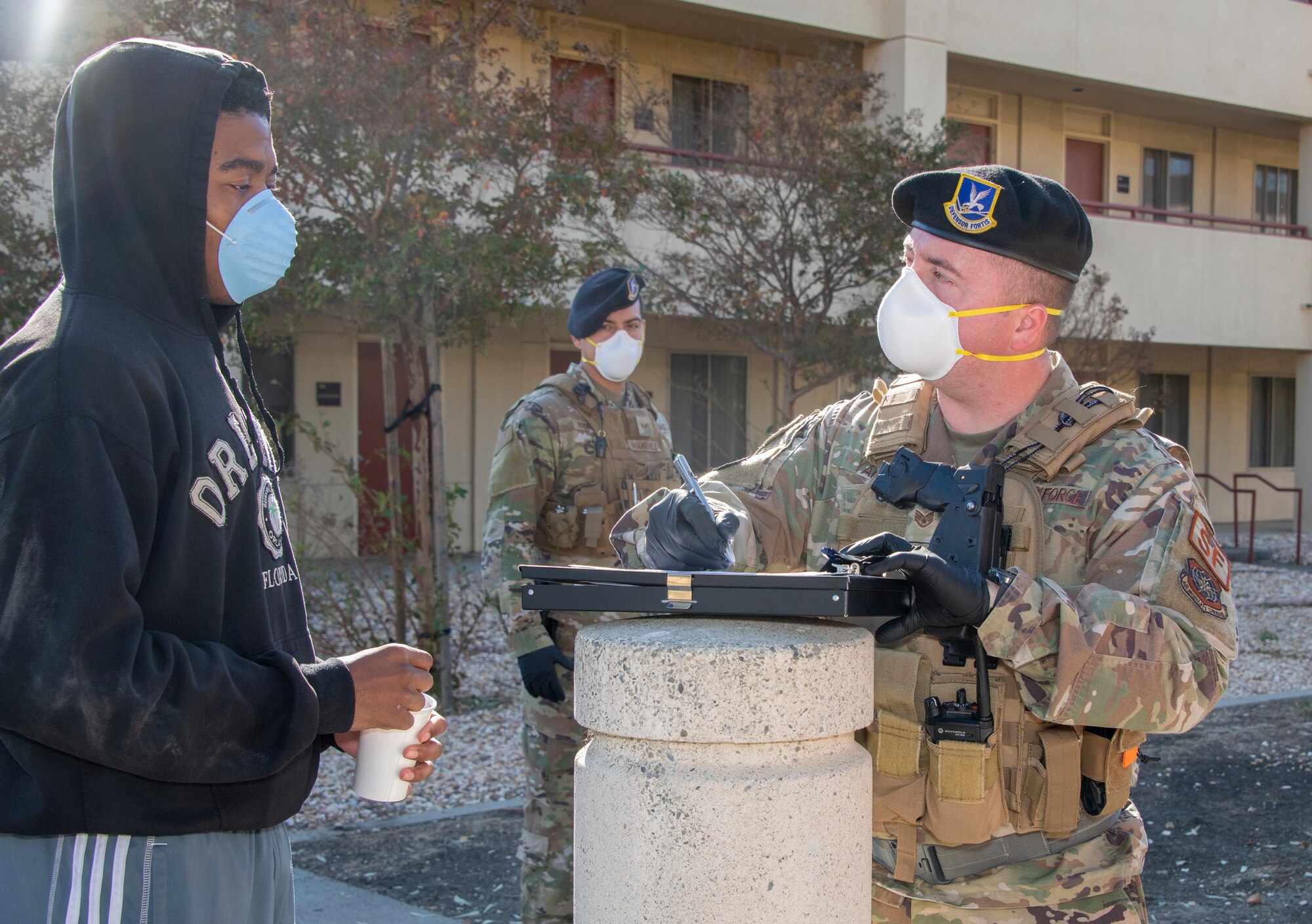 U.S. Air Force Staff Sgt. Joshua Yap, right, 60th Security Forces Squadron noncommissioned officer in charge of supply, processes Airman 1st Class Stanley Dinkins, left, 60th Force Support Squadron force management technician, into quarantine at an isolation facility during a base exercise Nov. 6, 2019, at Travis Air Force Base, California. The exercise tested Team Travis’ ability to respond to a public health emergency in the event of an actual health crisis. (U.S. Air Force photo by Heide Couch)