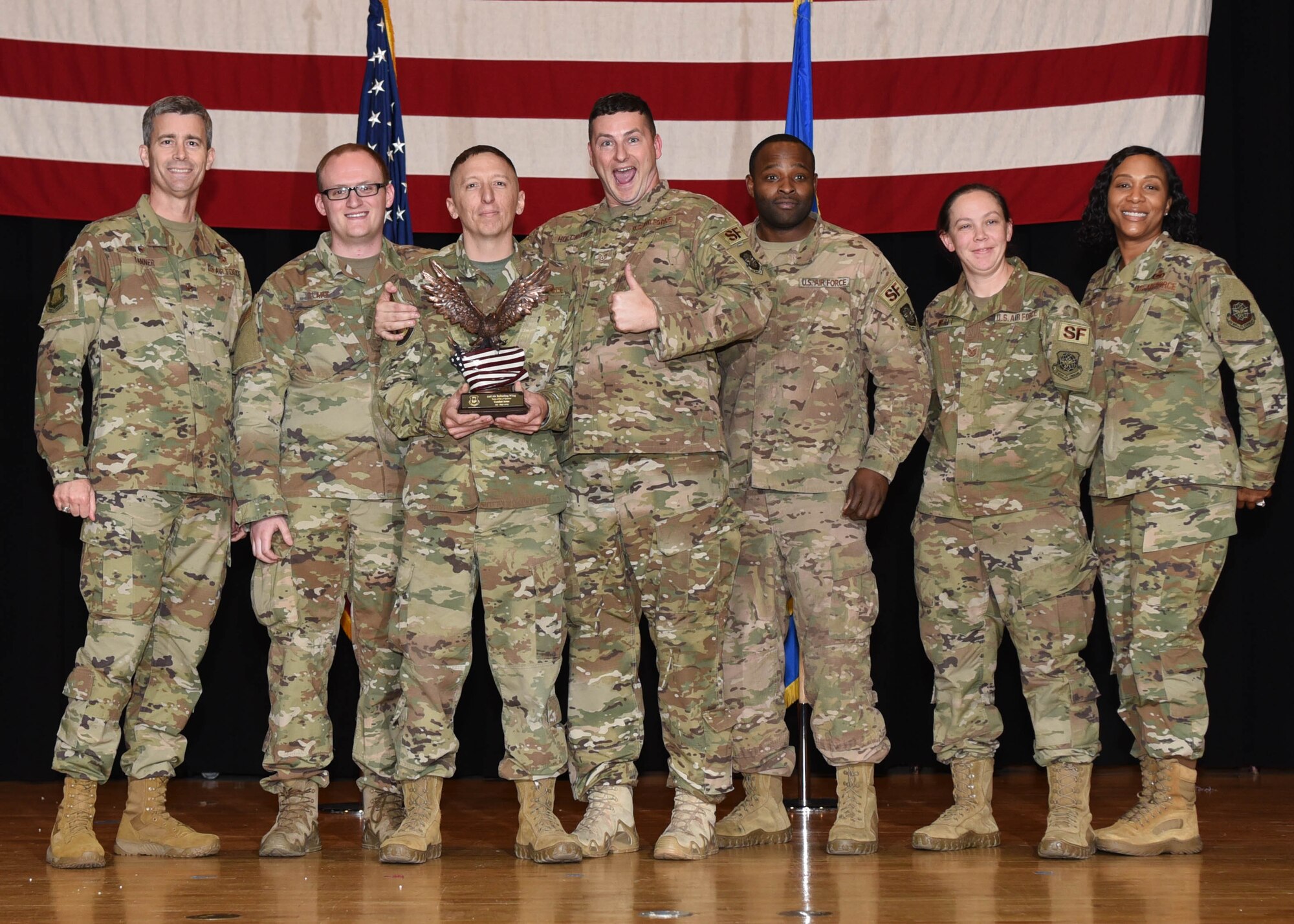 The 22nd Combat Arms section, 22nd Security Forces Squadron, receives an award Nov. 8, 2019, At McConnell Air Force Base, Kan. The 22nd Combat Arms section was one of five teams to go up for the 22nd Air Refueling Wing’s Team of the 3rd Quarter Award. (U.S. Air Force photo by Airman 1st Class Alexi Bosarge)