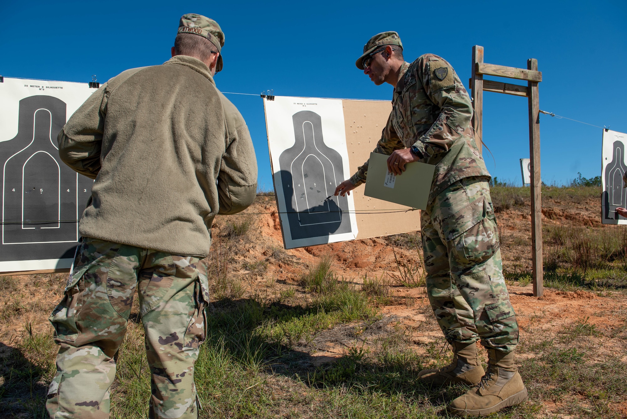 A German Armed Forces Proficiency Badge (GAFPB) competition proctor, right, reviews a participant’s target at Fort Jackson, South Carolina, Nov. 9, 2019.