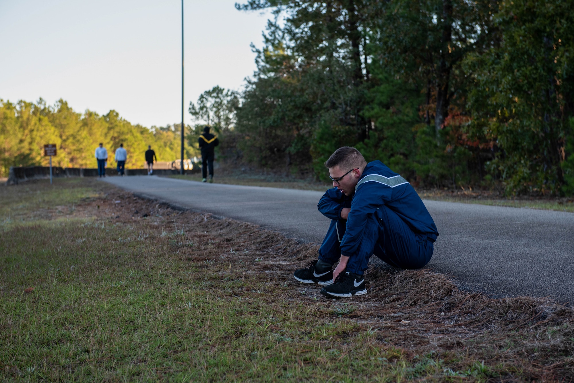 A U.S. Airman sits on the edge of the track after a 1000-meter sprint at the McCrady Training Center in Eastover, South Carolina, Nov. 9, 2019.