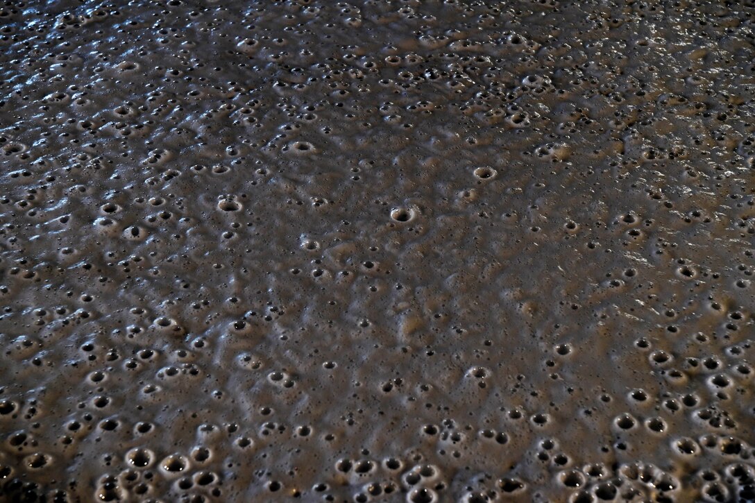 Firefighting foam spreads out across a container after being used to put out a test fire.