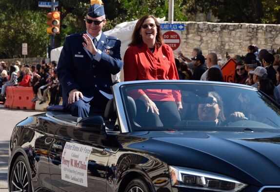 Col. Terry W. McClain, 433rd Airlift Wing commander and his spouse, Marci, interact with the spectators during the U.S. Military Veteran's Parade Association's parade through downtown San Antonio, Texas, Nov. 9, 2019. (U.S. Air Force photo by Staff Sgt. Lauren M. Snyder)
