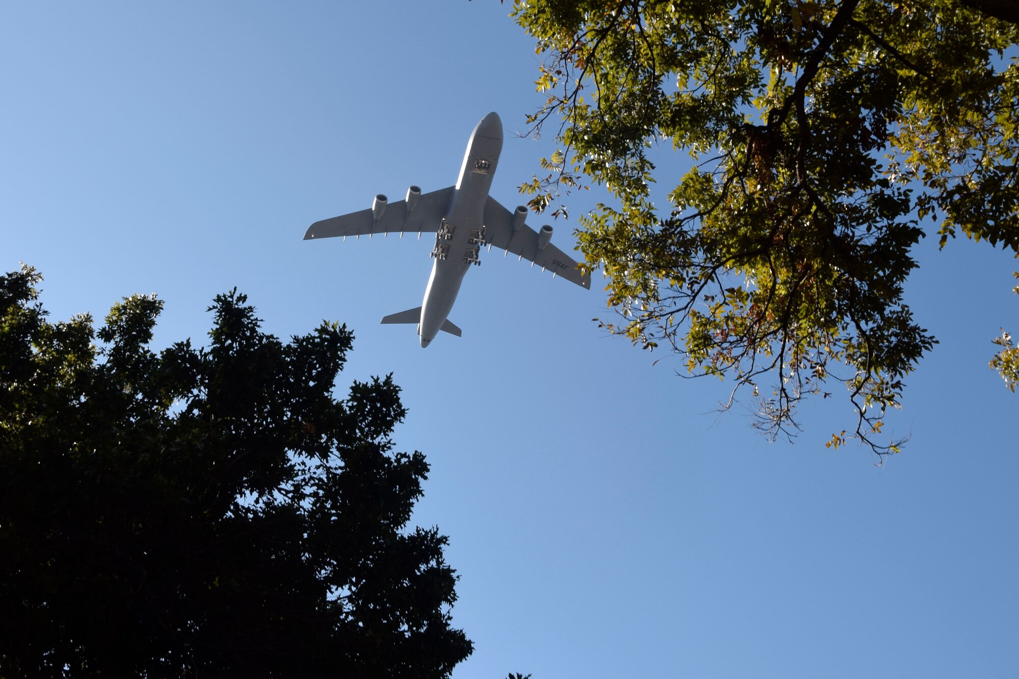 An Air Force Reserve Command C-5M Super Galaxy flies over the 20th anniversary U.S. Military Veteran's Parade Association wreath presentation at the Alamo in downtown San Antonio, Texas, Nov. 9, 2019. The aircraft is assigned to the 433rd Airlift Wing at Joint Base San Antonio-Lackland, Texas. (U.S. Air Force photo by Staff Sgt. Lauren M. Snyder)