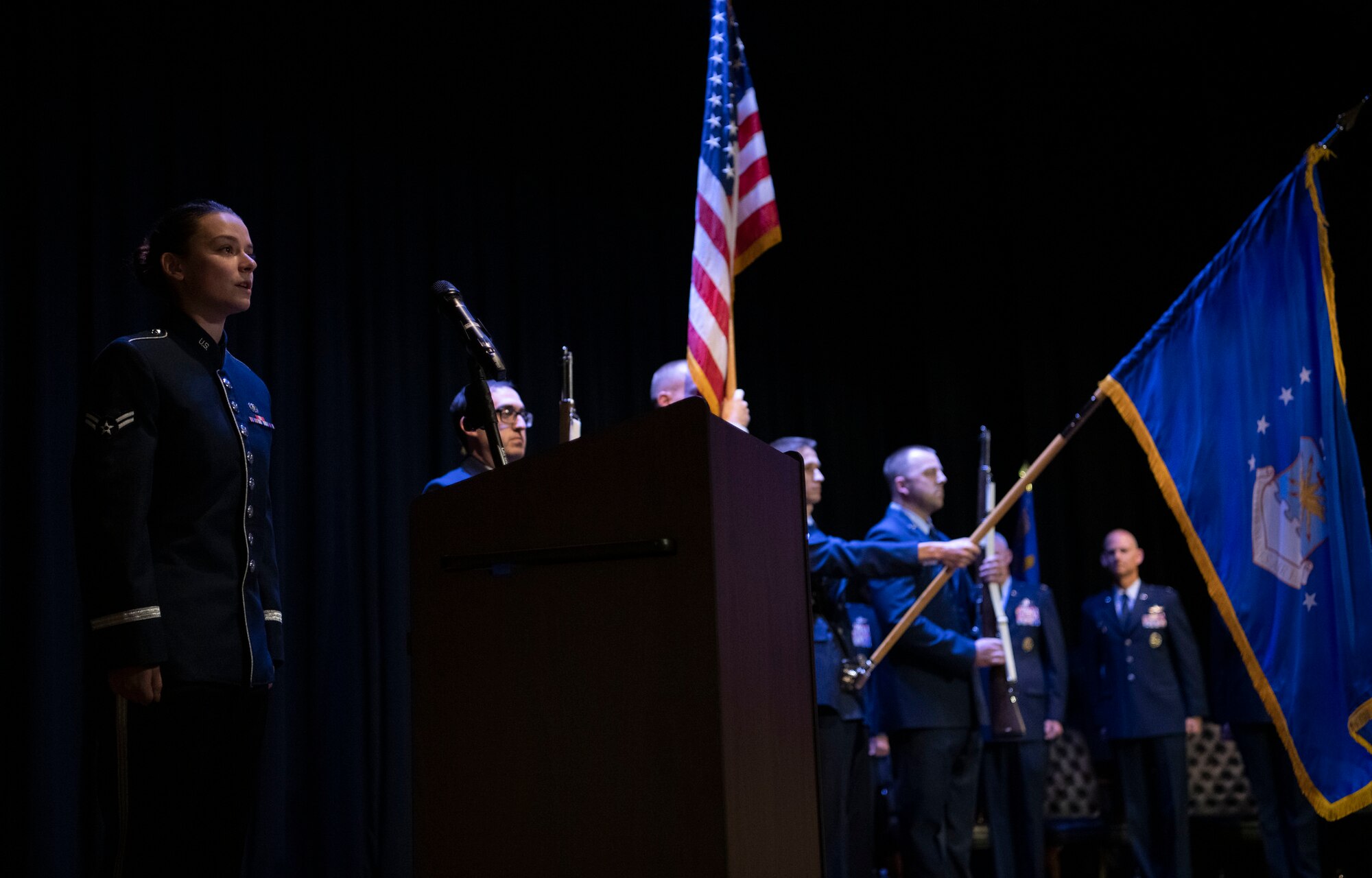 A1C Dana Bowers, Band of Mid America, Sings the anthem with CCC color guard in the background.