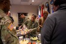 U.S. Navy Information Systems Technician First Class Albert Givens, president of Joint Task Force Civil Support’s Morale, Welfare and Recreation committee, serves nachos during a MWR event at the command. The nacho sale was one of many events held throughout the year to promote positive morale and well-being of personnel at the command. (Official DoD photo by Mass Communication Specialist 3rd Class Michael Redd/RELEASED)