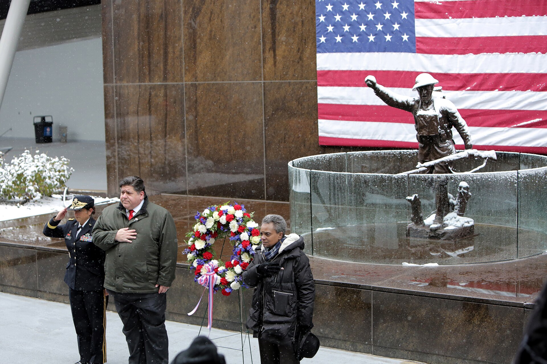 (From left to right) Brig. Gen. Kris A. Belanger, Commanding General, 85th U.S. Army Reserve Support Command; Illinois Governor J.B. Pritzker and Chicago Mayor Lori Lightfoot render honors as taps is played by the Doughboy statue at Soldier Field during the City of Chicago’s Veteran’s Day commemoration, November 11, 2019.