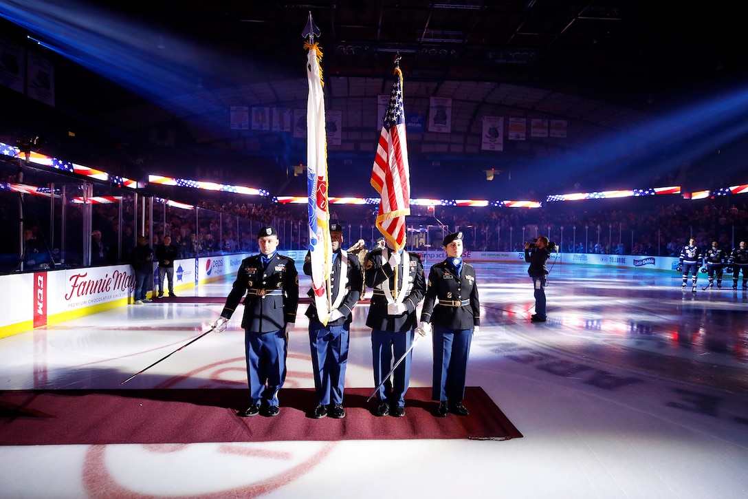 The 85th U.S. Army Reserve Support Command Color Guard team presents the Nation’s Colors before the start of a Chicago Wolves hockey game at the Allstate Arena in Rosemont, Illinois, November 9, 2019.