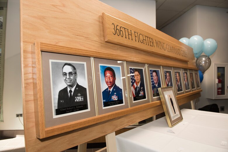 A wooden fixture holds the pictures of past 366th Fighter Wing command chief as a part of Chief Legacy Program ceremony, Nov. 11, 2019, at Mountain Home Air Force Base, Idaho. The fixture is part of a legacy wall within the 366th Fighter Wing used to document and honor prior command chiefs. (U.S. Air Force photo by Senior Airman Tyrell Hall)