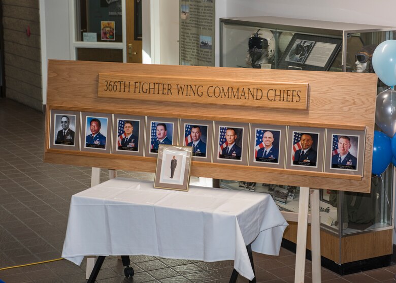 A wooden fixture holds the pictures of past 366th Fighter Wing command chief as a part of Chief Legacy Program ceremony, Nov. 11, 2019, at Mountain Home Air Force Base, Idaho. The fixture is part of a legacy wall within the 366th Fighter Wing used to document and honor prior command chiefs. (U.S. Air Force photo by Senior Airman Tyrell Hall)