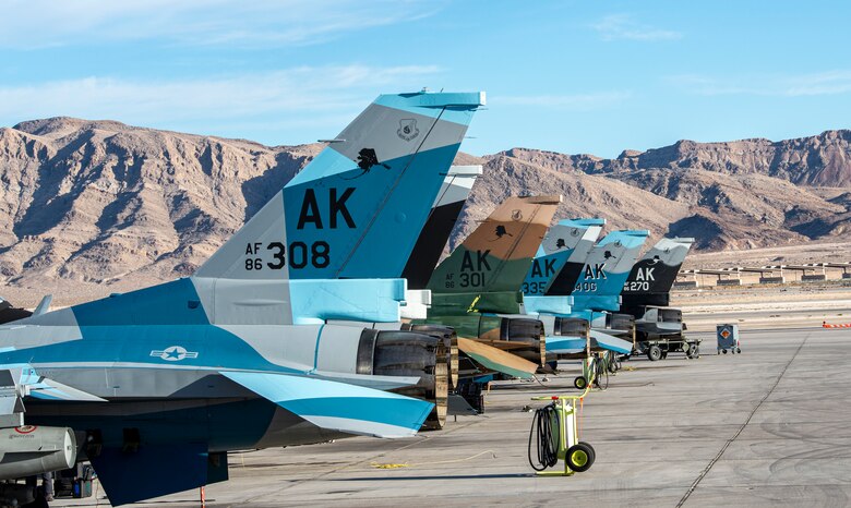 U.S. Air Force F-16 Fighting Falcons from 18th Aggressor Squadron are lined up on the flight line at Nellis Air Force Base, Nevada, Nov. 6, 2019. Eielson AFB sent a mobile training team, consisting of eight F-16s, to Nellis in support of the U.S. Air Force Weapons Instructor Course. (U.S. Air Force photo by Nellis Air Force Base Public Affairs)