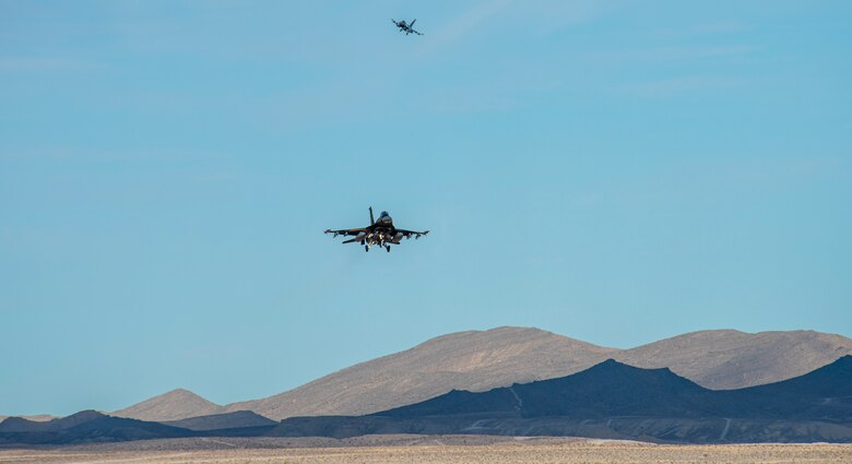 U.S. Air Force F-16 Fighting Falcons from 18th Aggressor Squadron fly over the flight line at Nellis Air Force Base, Nevada, Nov. 6, 2019. The Aggressor’s mission is to know, teach, and replicate a threat in order for other pilots to be able to overcome their adversaries. (U.S. Air Force photo by Nellis Air Force Base Public Affairs)