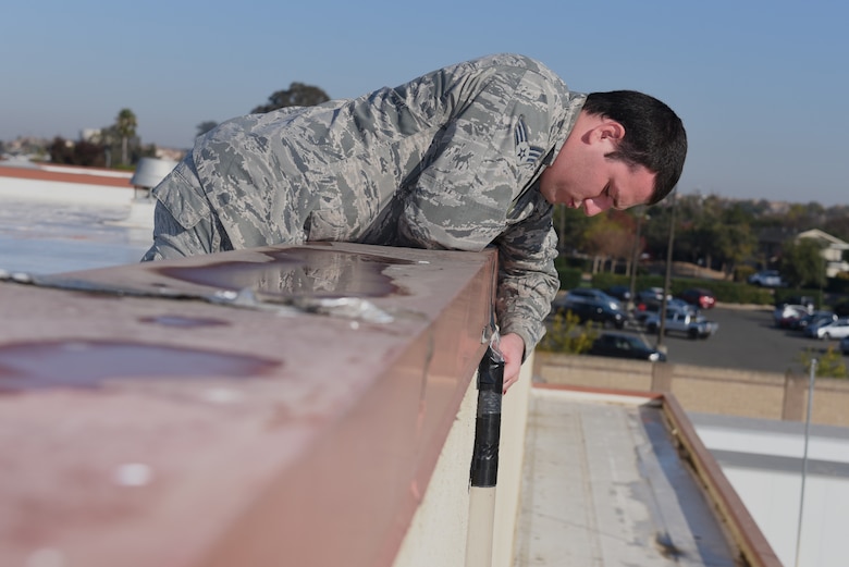 U.S. Air Force Senior Airman David De Alva, 60th Civil Engineer Squadron pest management technician, checks traps to see if there is any evidence of bats crawling through the pipes Nov. 8, 2019, at Travis Air Force Base, California. De Alva is trying to rid a building of bats by waiting for them to leave and blocking all entrances before they return. (U.S. Air Force photo by Airman 1st Class Cameron Otte)