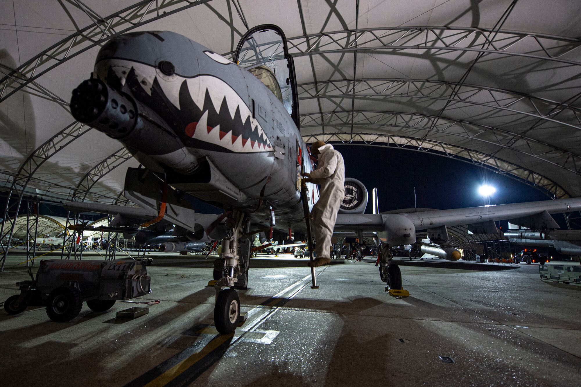 A photo of an Airman climbing a ladder on an aircraft