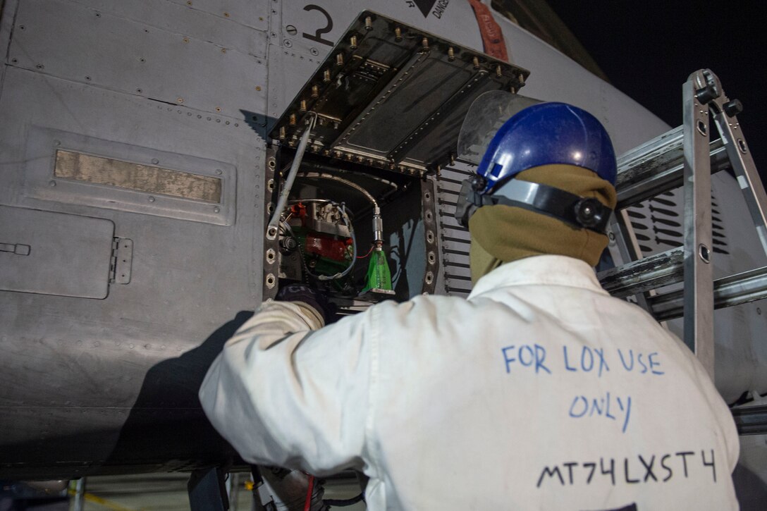 A photo of an Airman performing maintenance with liquid oxygen