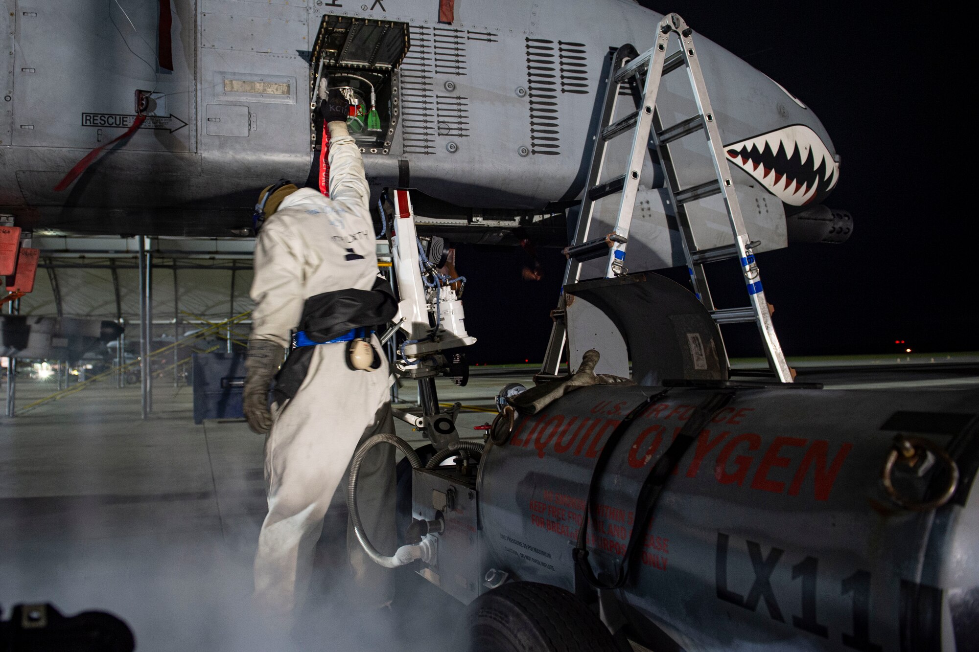 A photo of an Airman performing maintenance with liquid oxygen