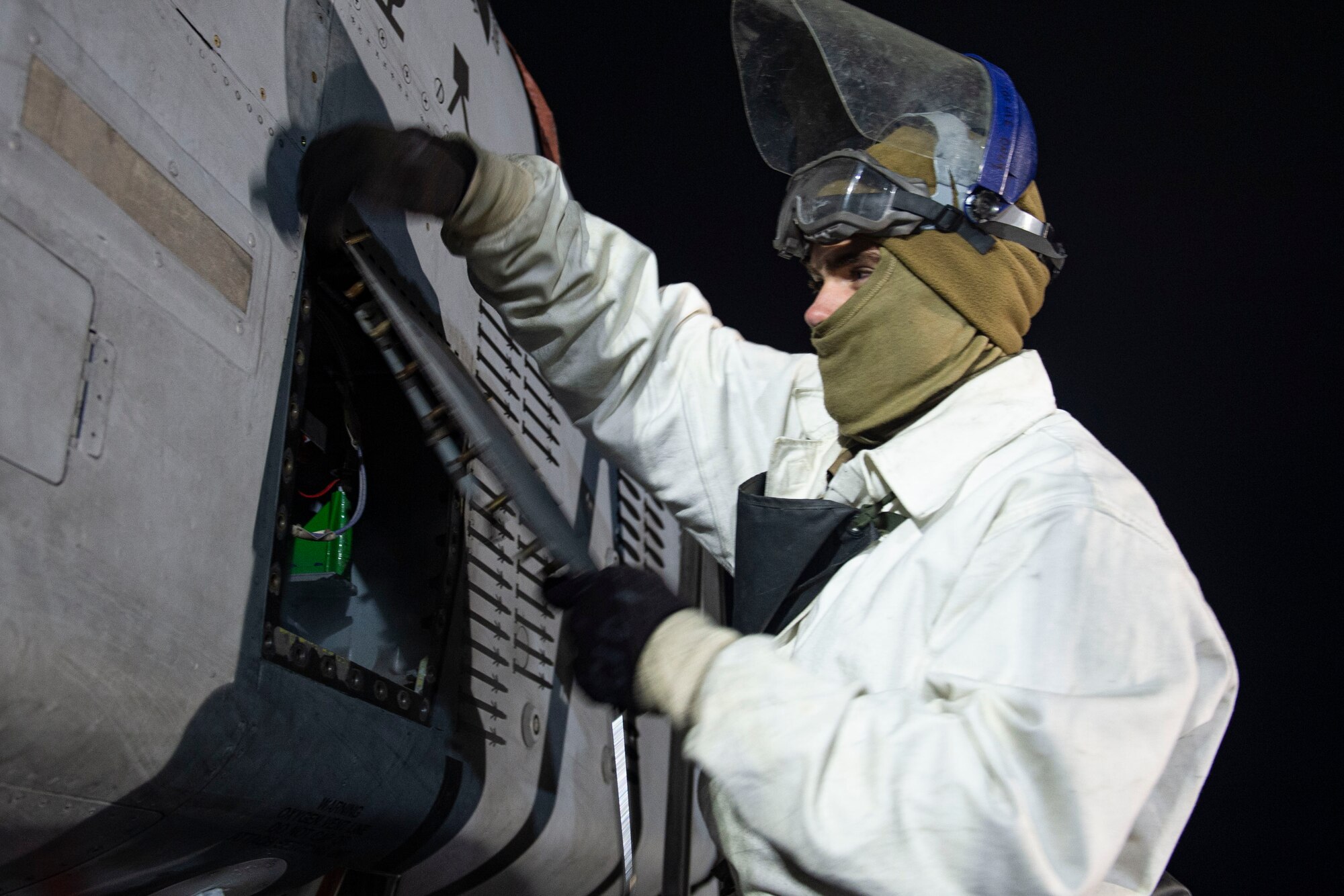 A photo of an Airman performing maintenance with liquid oxygen