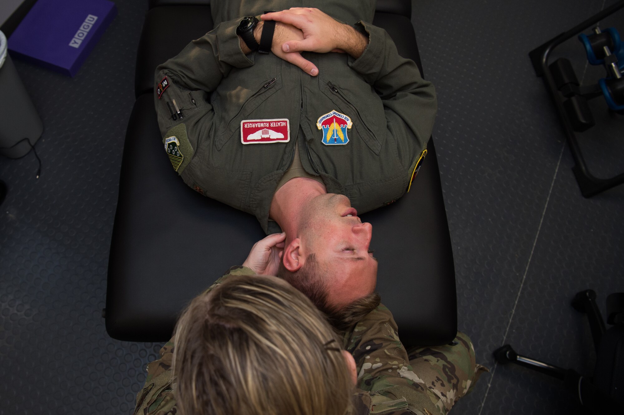 U.S. Air Force Capt. Michelle Jilek, 633rd Medical Operations Squadron physical therapist, examines Maj. Seth Rumbarger, 71st Fighter Squadron T-38 Talon pilot, at Joint Base Langley-Eustis, Virginia, Nov. 13, 2019. (U.S. Air Force photo by Senior Airman Tristan Biese)