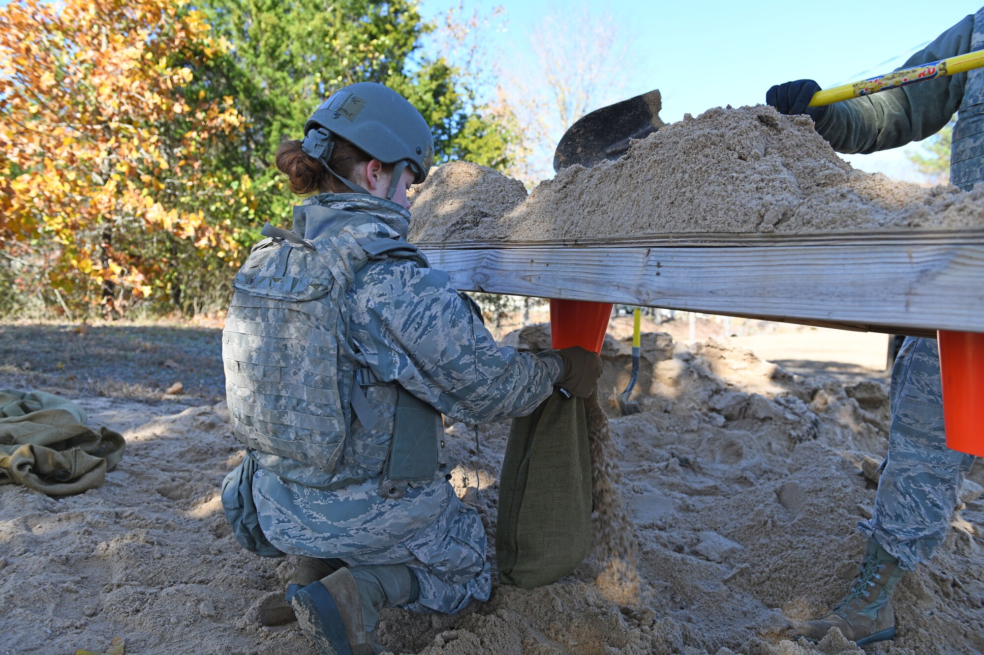 An Airman fills a sandbag