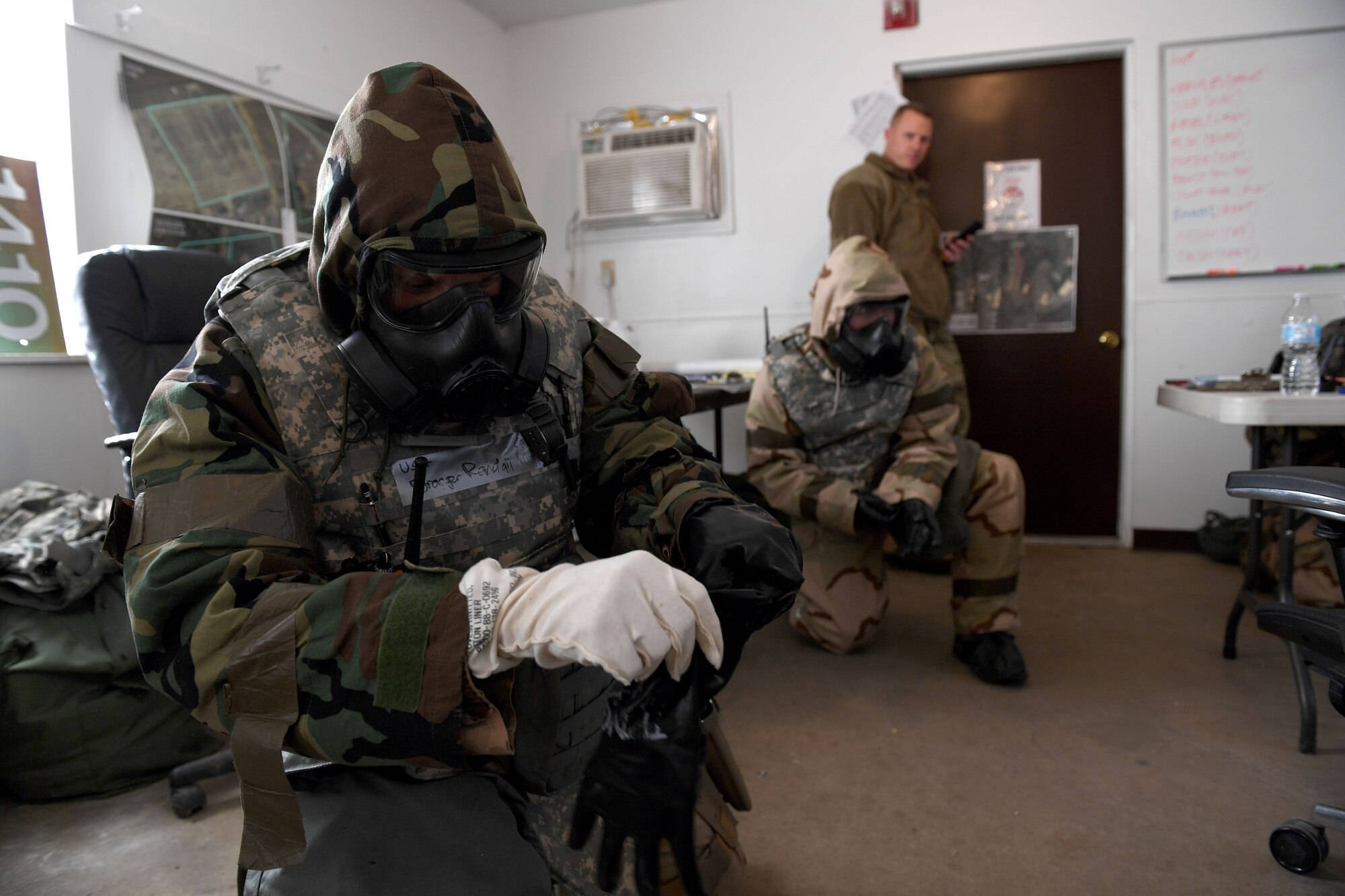 An Airman puts on gloves