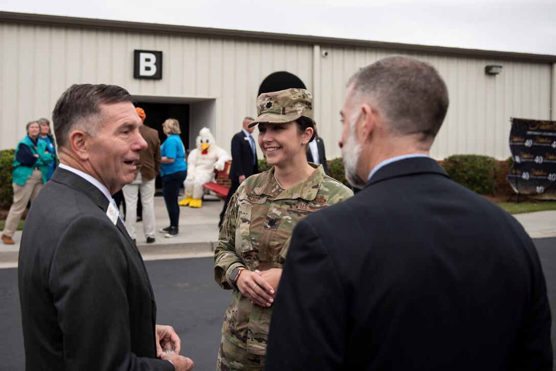 A photo of an Airman speaking with people from the local community during an event