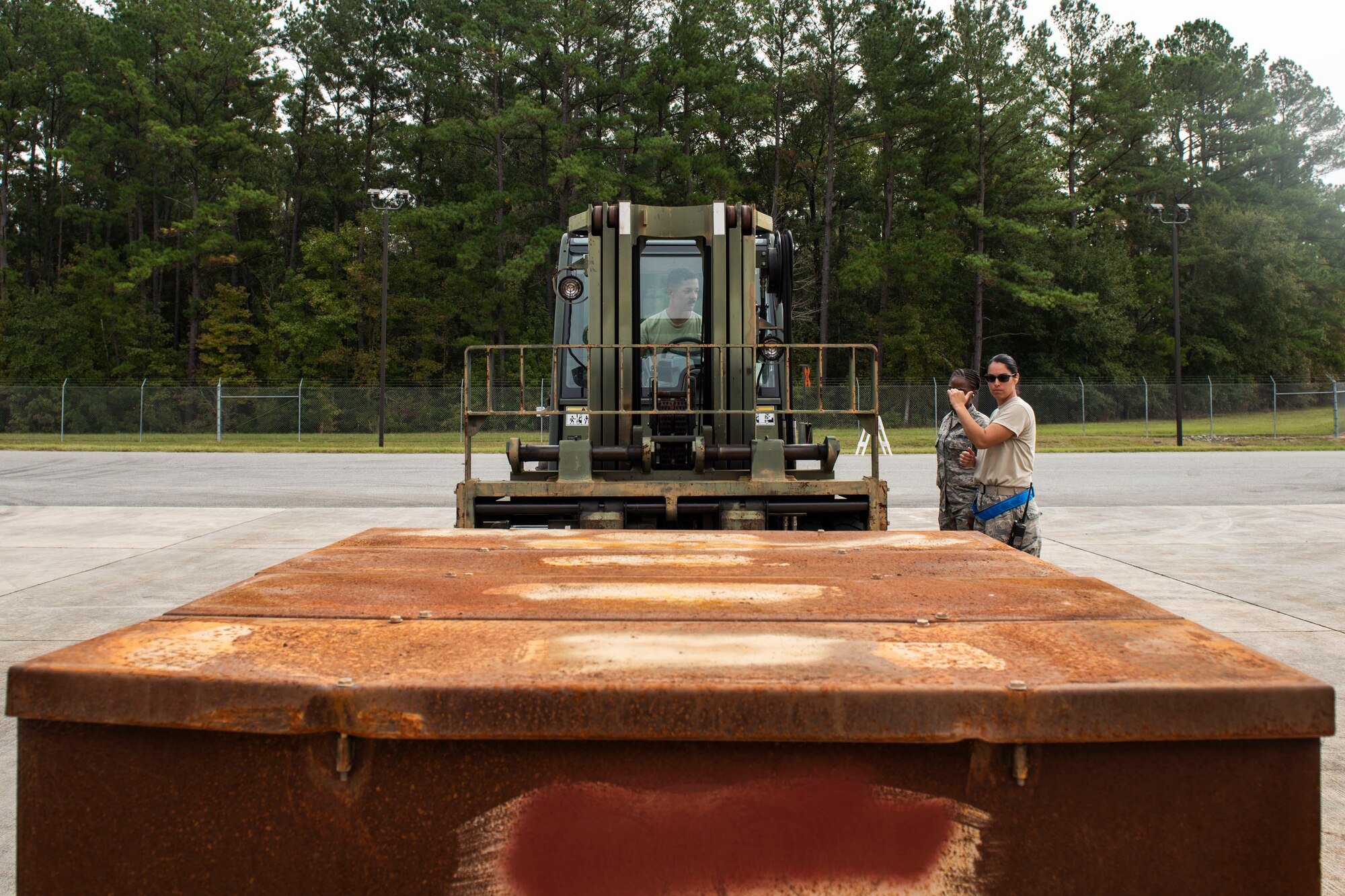 A photo of Airmen transporting munitions using a forklift