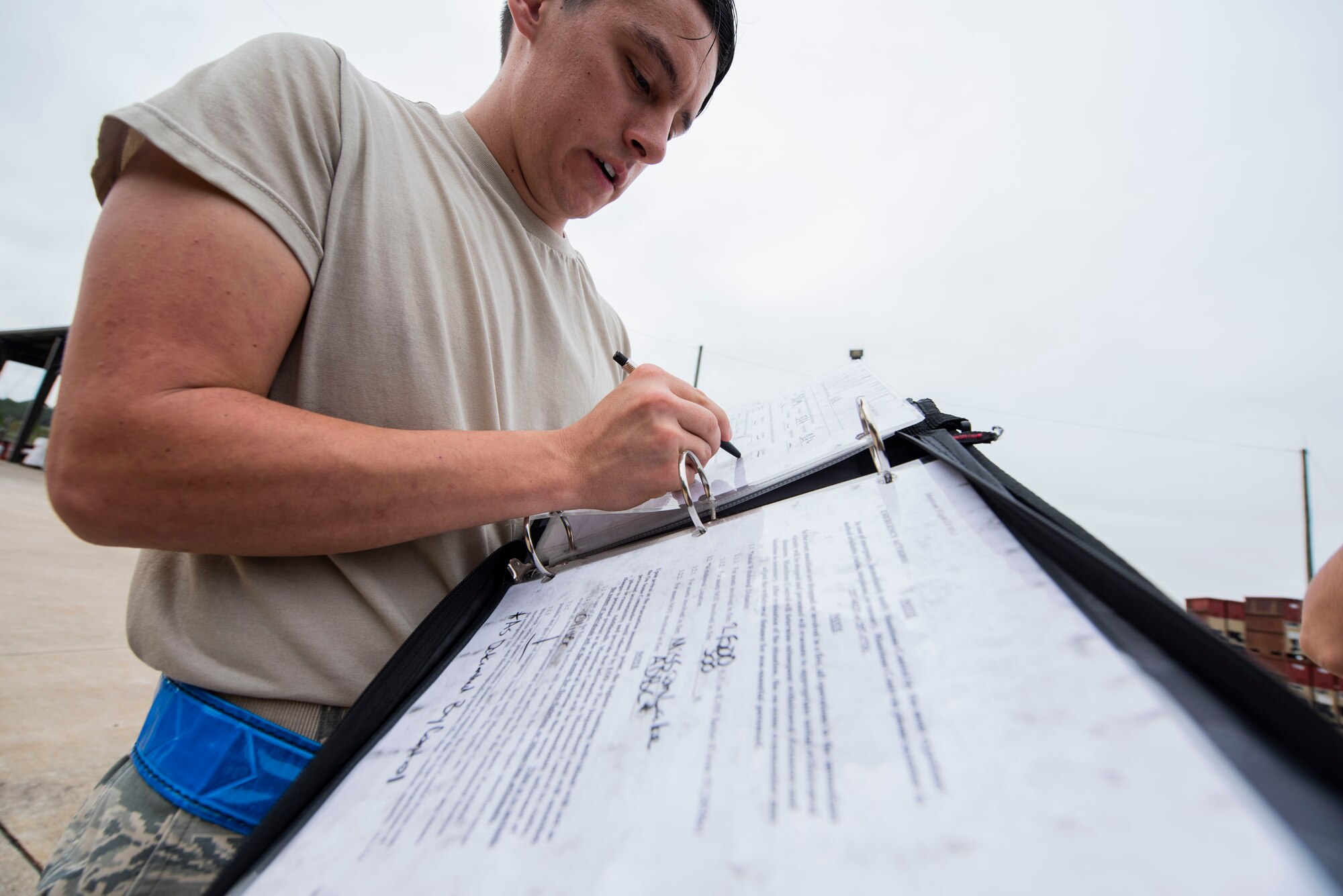 A photo of an Airman reading technical orders for an aircraft