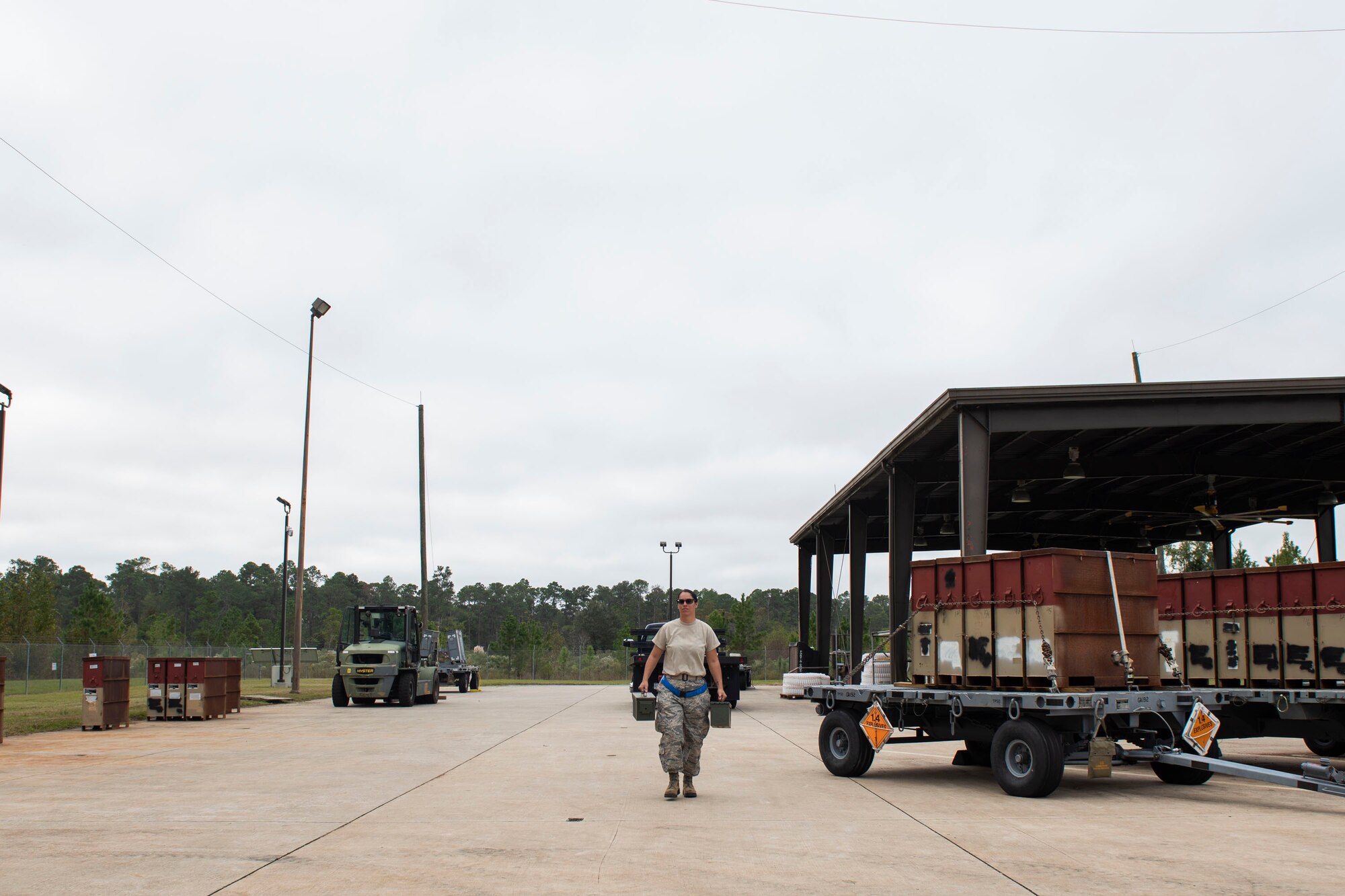 A photo of an Airman carrying munitions