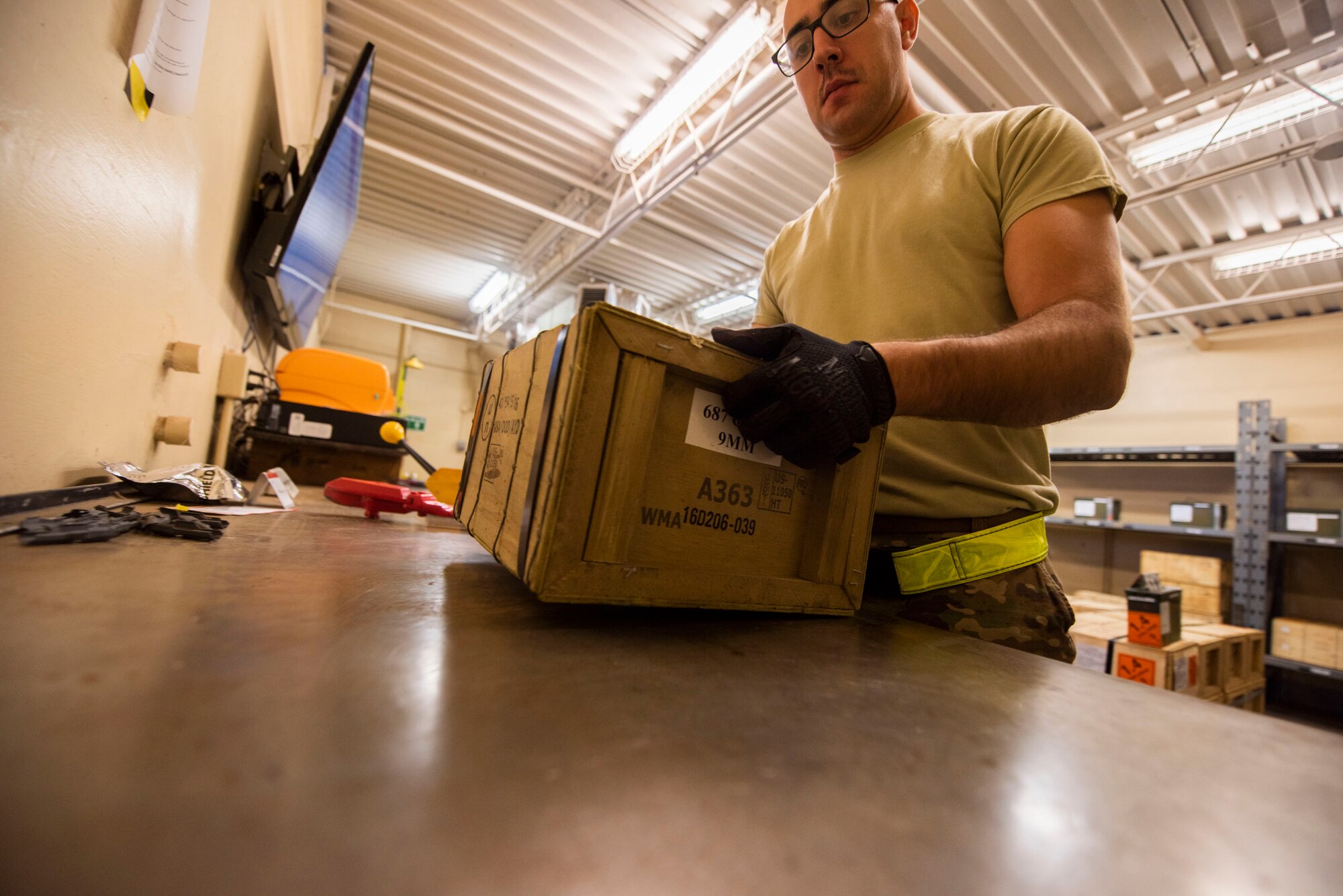 A photo of an Airman preparing to inspect a shipment