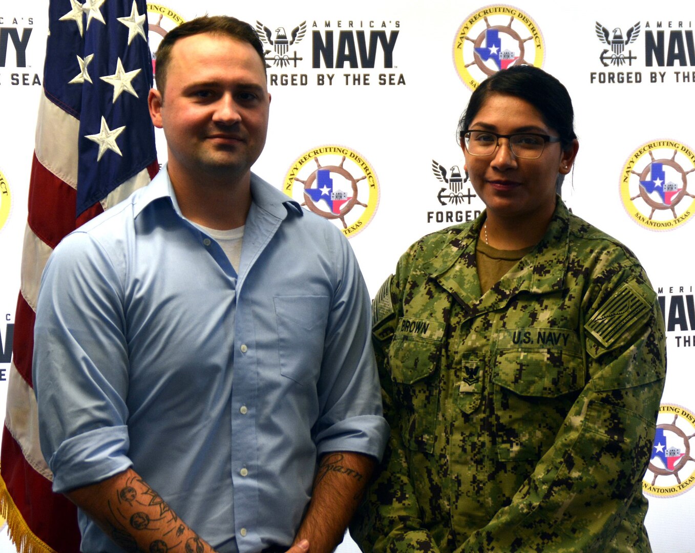 Petty Officer 3rd Class Christian Brown (left) rejoined America’s Navy as a Reservist during an enlistment ceremony held at Navy Recruiting District San Antonio headquarters Oct. 16.  Brown first entered the Navy in 2013 serving four years and will be assigned to Navy Operations Support Center San Antonio. He is joined by his wife, Petty Officer 2nd Class Angelica Brown, the NRD San Antonio community relations coordinator.