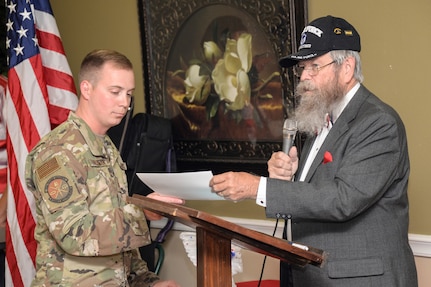 Chaplain Albert Owens, the event emcee, gives Tech. Sgt. Caleb Hoferman, 343rd Training Squadron Block One Instructor, a certificate to present to a veteran at a Veterans Day ceremony at Legend Oaks Healthcare and Rehabilitation in San Antonio Nov. 8.