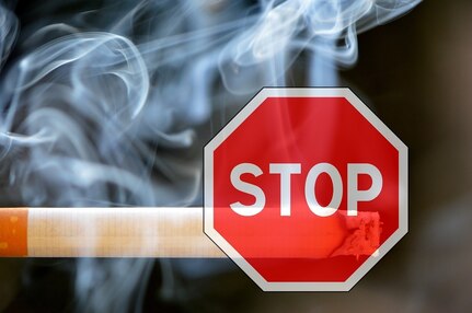 Image of lit cigarette with a stop sign.
