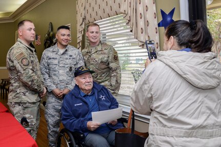 Staff Sgt. Bradley Rayburn, Staff Sgt. Victor Medina-Ornelas and Tech. Sgt. Caleb Hoferman, 343rd Training Squadron Block One Instructors, pose for a photo with a veteran at a Veterans Day ceremony at Legend Oaks Healthcare and Rehabilitation in San Antonio Nov. 8.