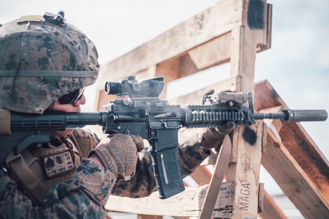 U.S. Marine Corps Sgt. Martin Vara, a scout sniper team leader with Weapons Company, Battalion Landing Team 3/5, 11th Marine Expeditionary Unit, fires an M4A1 carbine from behind cover during a small arms range aboard the San Antonio-class amphibious transport dock ship USS John P. Murtha. The Marines and Sailors of the 11th MEU are conducting routine operations as part of the Boxer Amphibious Ready Group in the eastern Pacific Ocean.