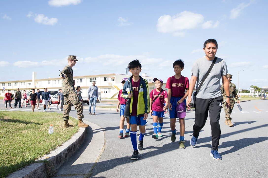 Participants walk during a Tsunami Evacuation Drill at Camp Foster, Okinawa, Japan, Nov. 9, 2019. The drill was held to convey the readiness and capabilities of the camp to members of the U.S. and local communities in the event of an emergency.