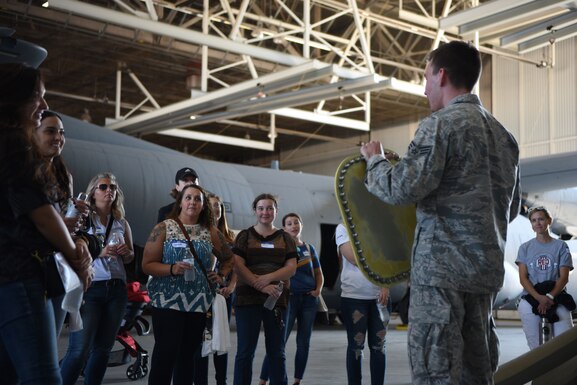 A Dyess Airman briefs a group of spouses at Dyess Air Force Base, Texas, Oct. 5, 2019. Spouses of Dyess Airmen toured the 317th Maintenance Squadron, 317th Aircraft Maintenance Squadron and the 317th Operations Support Squadron as a part of the 317th Airlift Wing Spouse Day. (U.S. Air Force photo by Airman 1st Class Colin Hollowell)